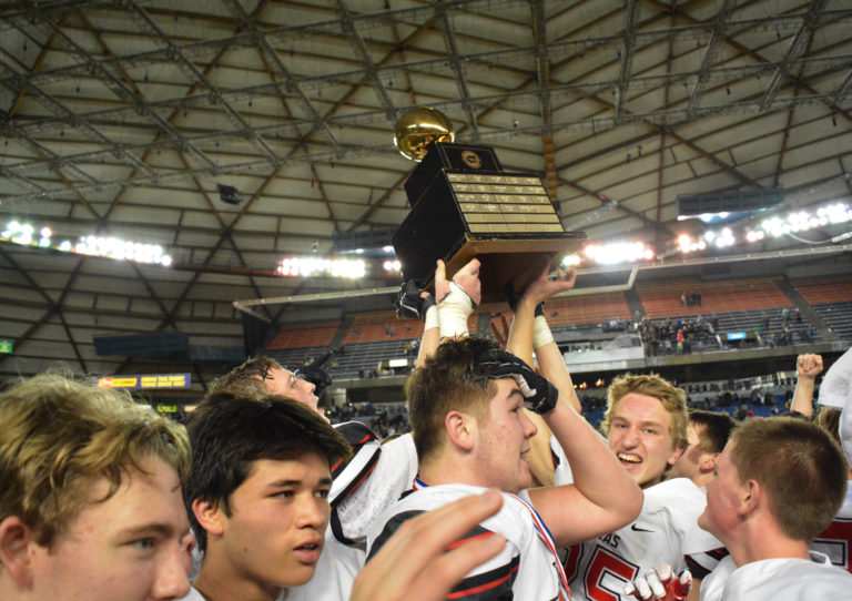 Marshall McIvor (middle) and the Camas High School football players achieved their dream of becoming state champions.