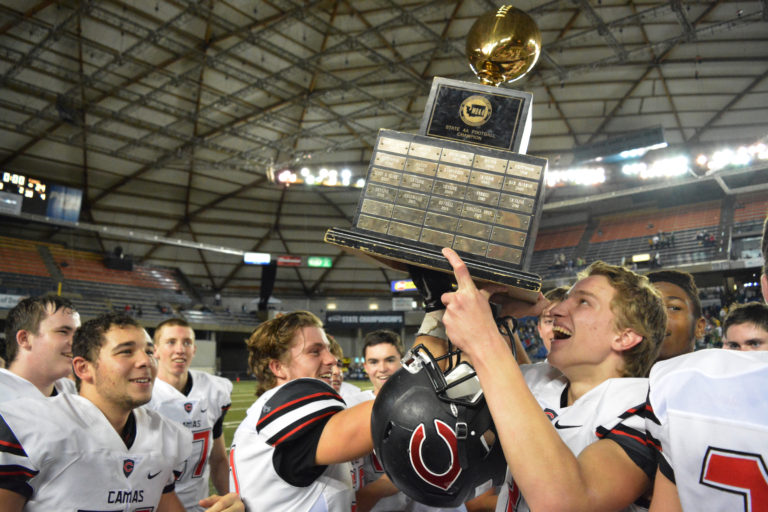 Camas football players hold the state championship trophy up high for everybody to see.  The Papermakers defeated the Richland Bombers 24-14 at the Tacoma Dome Saturday, Dec. 3. 