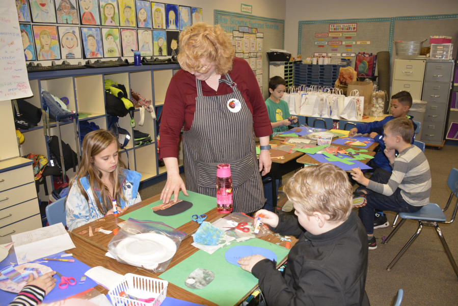 Gause artist in residence Peggy Ross assists students with the animal collage process, which took place after students researched and wrote an informational paragraph about their animal.