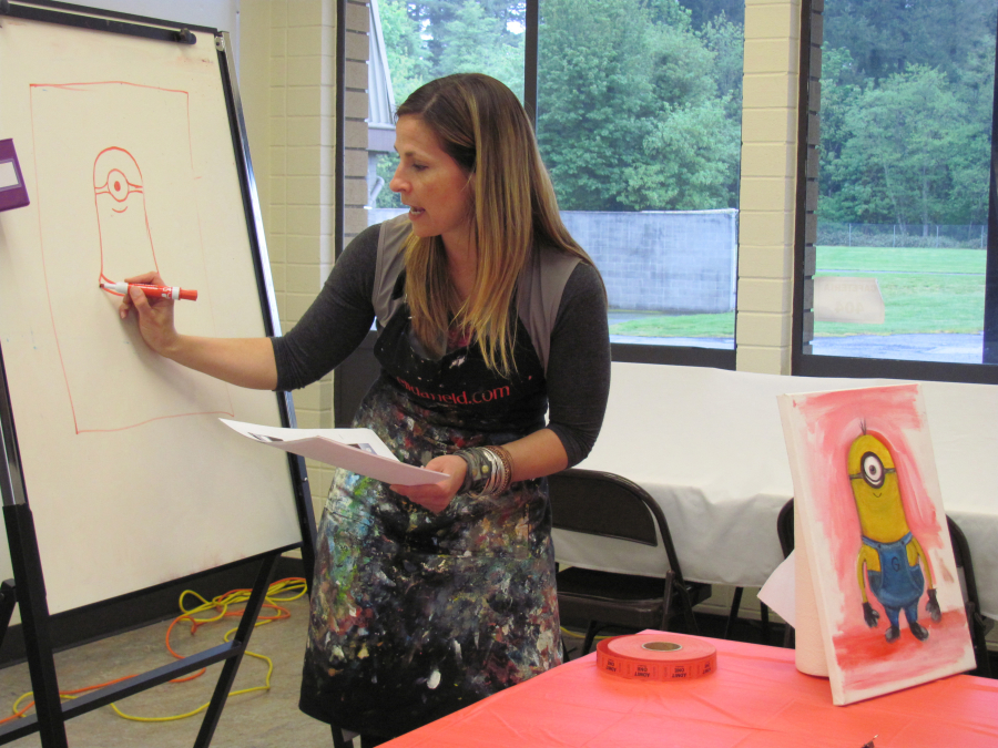 Artist Elida Field demonstrates how to draw a Minion during an Art Van Go class in Camas.