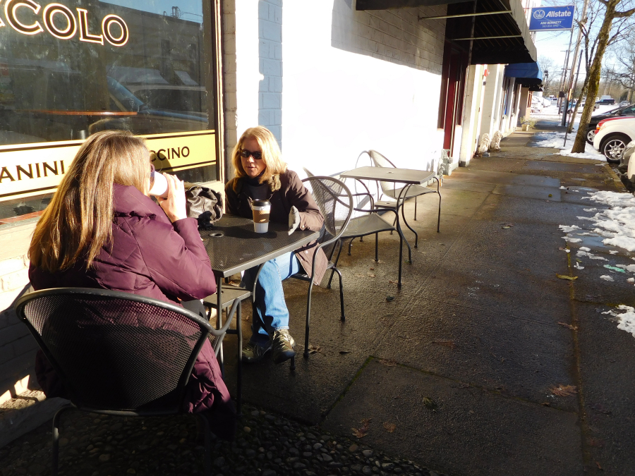 Dorrie Best and Debbie Schmid, both of Washougal, enjoyed tea from Caffe Piccolo in downtown Camas, Jan. 12. "I feel like I'm at a ski resort," Schmid said. They sat outside, while their daughters shopped for vinyl records at Camas Antiques.
