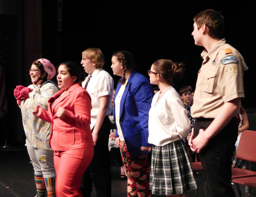 Rona Lisa Peretti (Shelby Brock) educates the spellers.