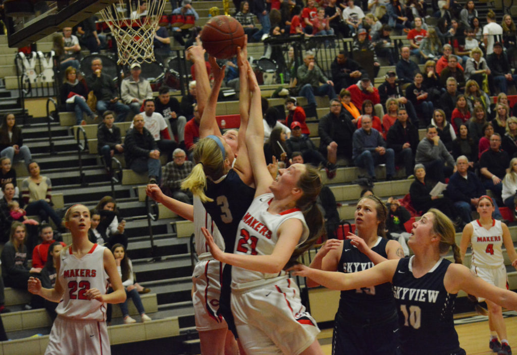 Emma Jones and Courtney Clemmer go for the rebound off the basket for Camas.