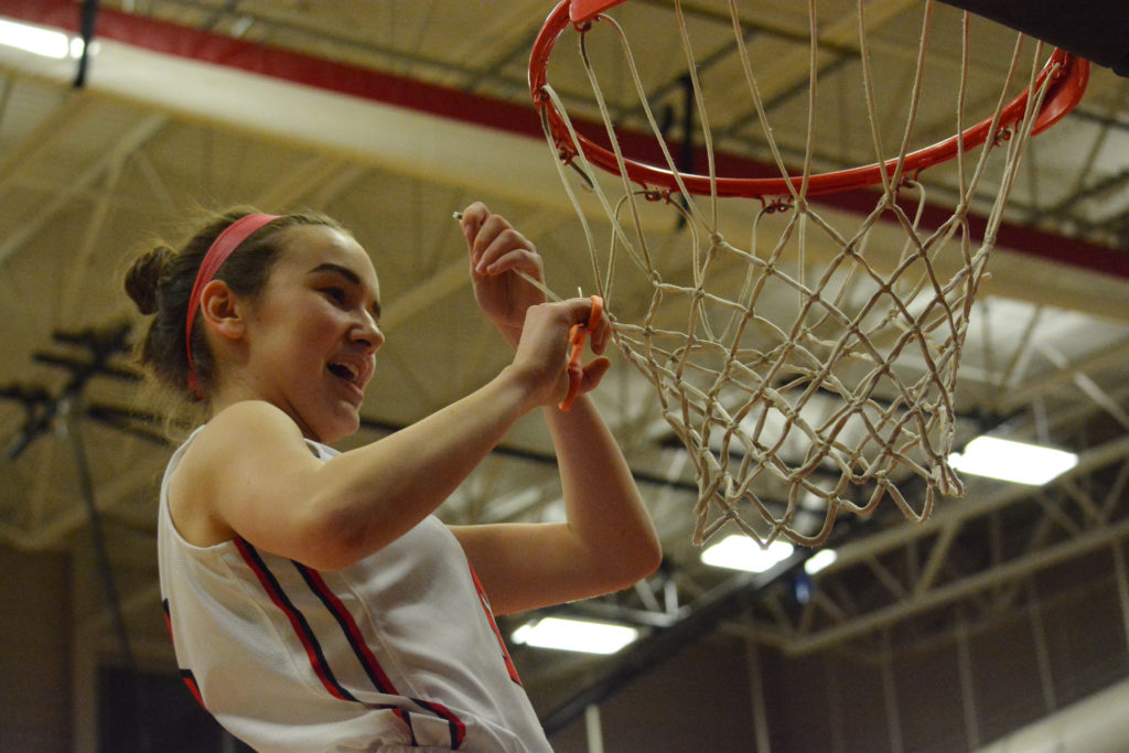 Jillian Webb cuts down a piece of the net.