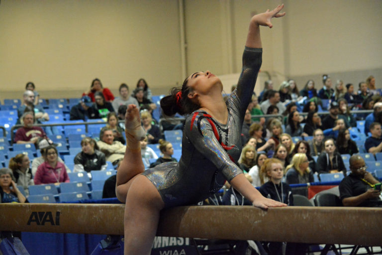 Alexa Dietz performs on the balance beam for the Papermakers in the 4A state team competition at the Tacoma Dome Friday.