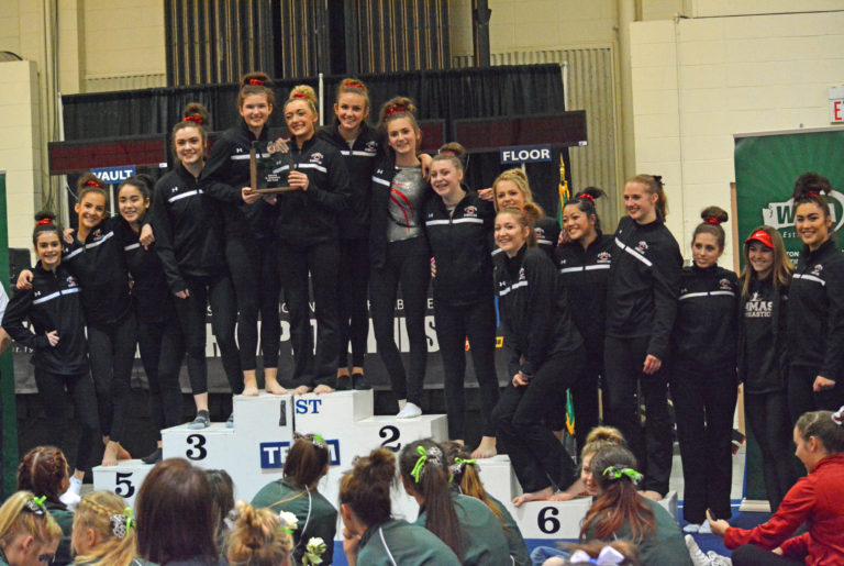 The Camas High School gymnastics team stands on the podium in second place at the 4A state meet Friday, at the Tacoma Dome.