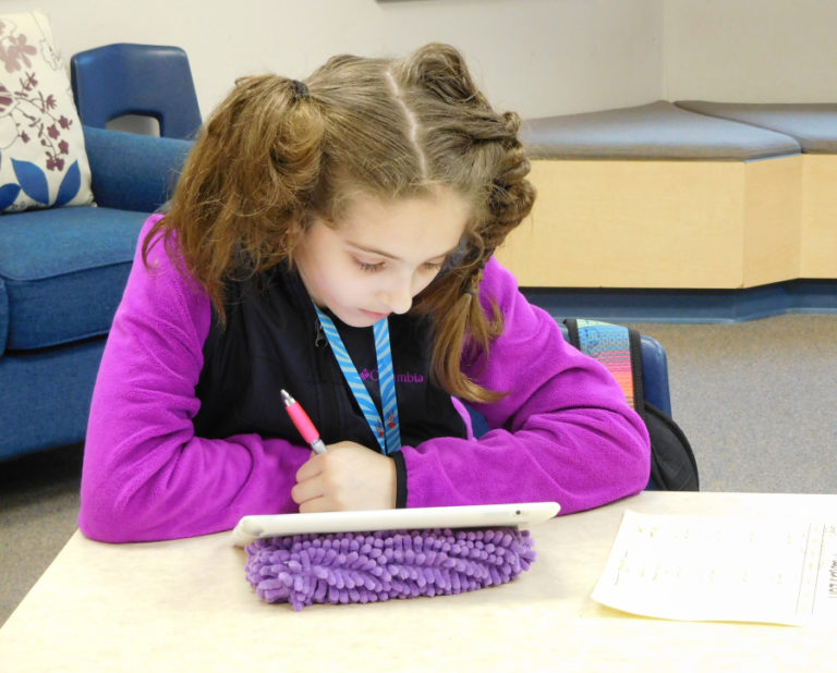 Fifth-grader Kennedy McFadden enjoys using her iPad to write codes.