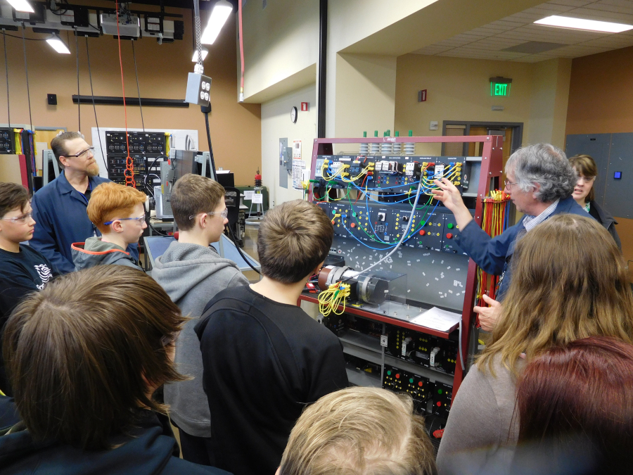 Professor Christopher Lewis (left) and instructor Kenneth Luchini explain the various uses of circuit boards during a visit by JMS students to the mechatronics lab at Clark College Columbia Tech Center.