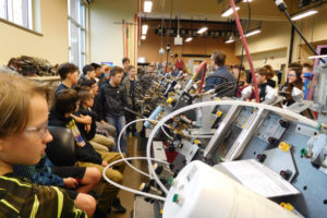 Eighth-graders from Jemtegaard Middle School inspect one of the hydraulics machines at the Clark College's Columbia Tech Center campus on Friday. The mechatronics program is where electronics and machinery meet. 