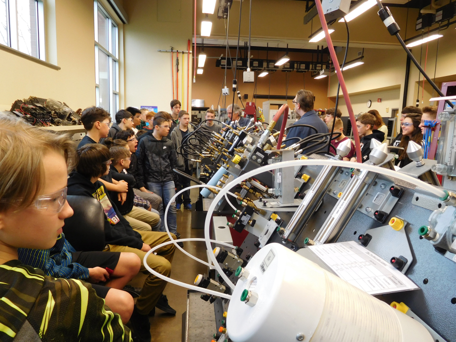 Eighth-graders from Jemtegaard Middle School inspect one of the hydraulics machines at the Clark College's Columbia Tech Center campus on Friday. The mechatronics program is where electronics and machinery meet. 