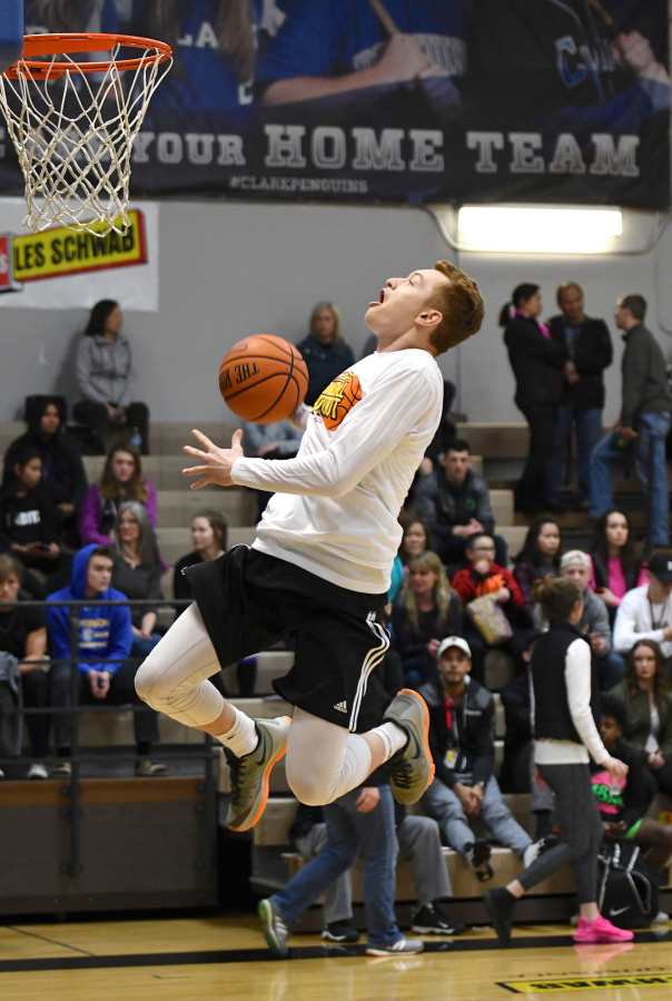 Washougal High School senior Collin Prangley hangs in the air during the slam dunk contest at the Les Schwab Tires Roundball Shootout March 26, at Clark College.
