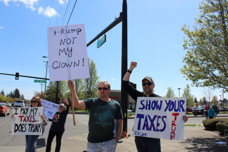 Brandon Wick (right), co-organizer of the Camas Progressives group, demonstrates with his wife Summer Wick (left); Brian Little (second from right), a lifelong Camas-Washougal resident; and Camas resident Rebecca Keith (second from left) at a Tax Day rally urging President Donald Trump to release his tax returns on Saturday, April 15.