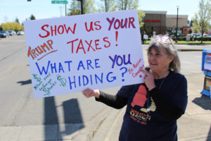 Rebecca Keith, of Camas, attends a Tax Day demonstration with the Camas Progressives group in east Vancouver, on Saturday, April 15. 