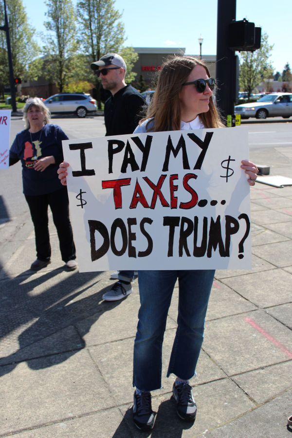 Camas resident Summer Wick holds a sign at a Camas Progressives Tax Day rally on Saturday, April 15.