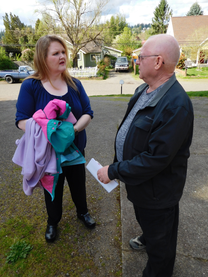 RaeShel Peck chats with one of her neighbors, Leif Leifsen, on the 3400 block of &quot;K&quot; Street, in Washougal.