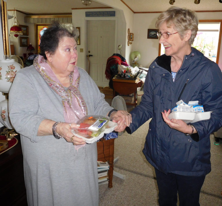 Reiter (right) catches up with client Alice Olsen during a recent Meals on Wheels delivery. Both women share a love of plants.