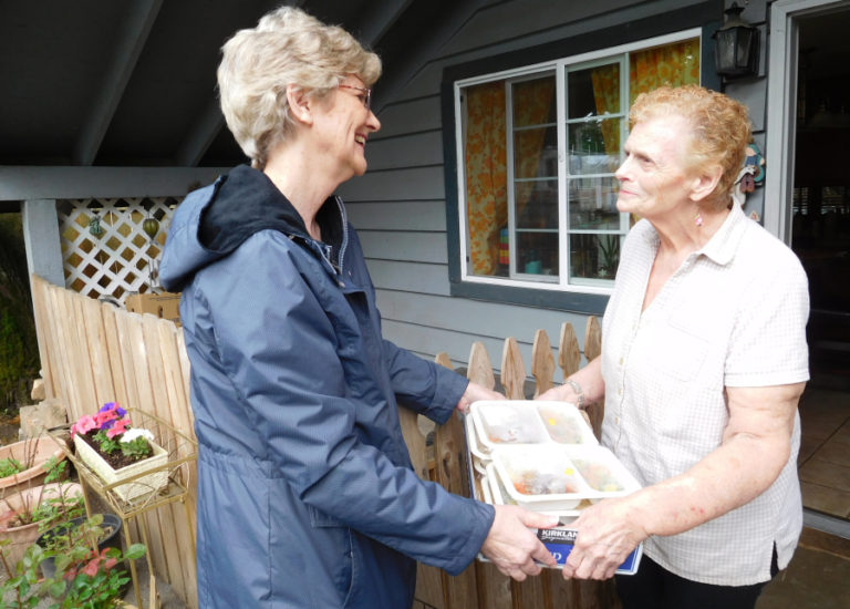 Reiter (left) chats with client Alice McNett during a recent delivery.