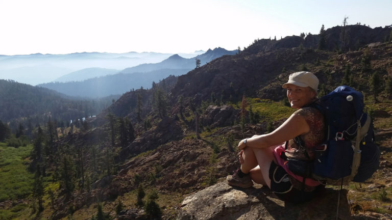 Boni enjoys a rest and view of Sierra Buttes Pinnacles.
