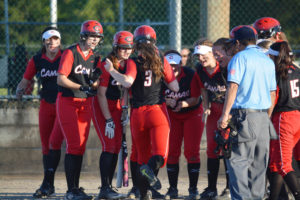 Peyton Bates greets her Camas softball sisters at the plate after hitting a 3-run home run in the bi-district tournament Friday in Enumclaw. After losing in the first round, the Papermakers won three straight games to qualify for state in Spokane. 