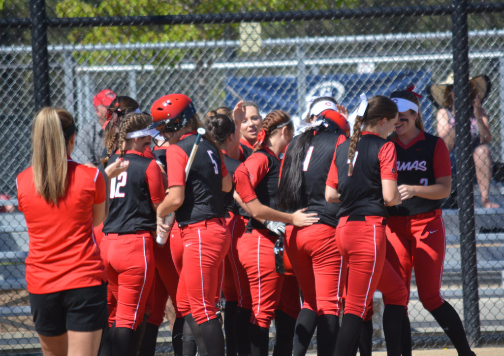 The Camas High School softball team celebrates at home plate after Callie Johnson hit a home run in the first game of the state tournament, at the Merkel Sports Complex in Spokane. The Papermakers won four of their six games to finish in fourth place.