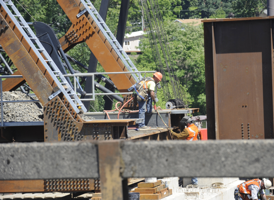 Workers assist with the BNSF Railway Washougal River bridge replacement in Camas, on Monday, June 5. 