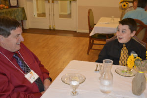 Mentor Larry Keister and Hathaway fifth-grader Myckeal Parker enjoy a three-course meal at Columbia Ridge Senior Living during a real-life lesson in fine dining as part of the "Young Men in Action" program. (Contributed photo)