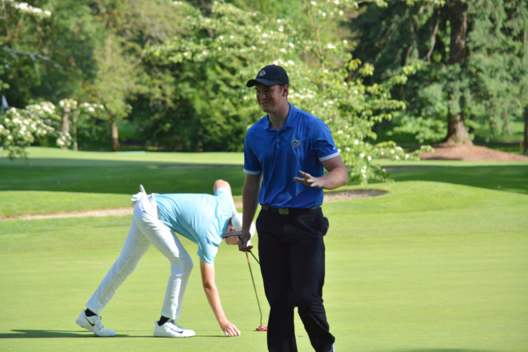 Brian Humphreys (right) waves to the crowd after a birdie on 13 at Royal Oaks.