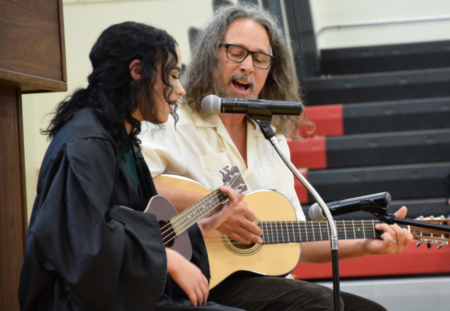 Angelica Heyman, accompanied by teacher Daniel Harvey, sings "Rest Easy," an original song, at the Hayes Freedom High School  commencement.