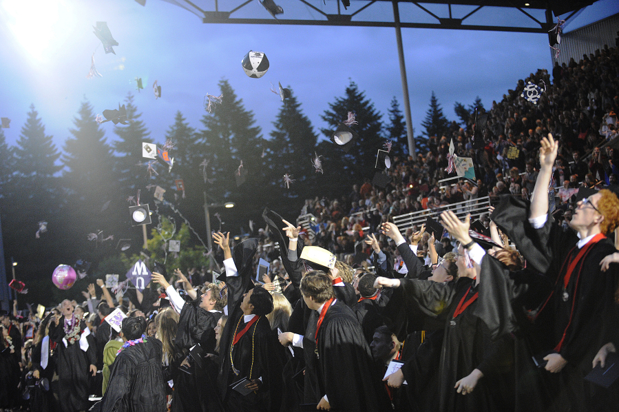 Camas High School graduates mark the end of commencement ceremonies by throwing caps, beach balls, tassels and other items in the air in celebration.  All four local high schools held graduation ceremonies last weekend. 