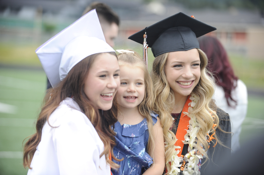 Generations of family members celebrate with flowers, balloons and hugs on the Fishback Stadium football field, following the Washougal High graduation ceremony on Saturday, June 17.