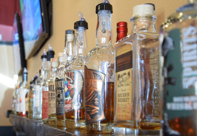 The spirits display behind the bar in the lounge of Mill City Brew Werks on June 20. Mill City serves only spirits from Pacific Northwest distilleries.