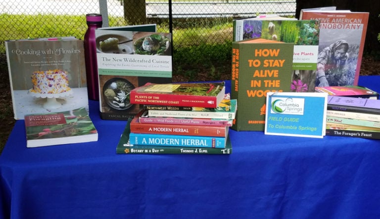 A plethora of books lined one of the tables during Eve Hanlin&#039;s foraging workshop at Columbia Springs on Saturday.