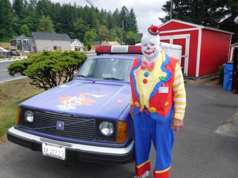 &quot;Klutz, the Magnificent,&quot; also known as Jim Cobb, of Washougal, stands next to a 1976 Volvo station wagon with loud speakers and flashing lights that will be in the Camas Days grand parade at 11 a.m., Saturday, July 22, in downtown Camas. Cobb is a member of Southwest Washington Afifi Shrine Clowns Unit of Afifi Shriners that make monthly visits to the Shriners Hospital for Children, in Portland.