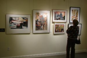 A visitor peruses artwork at the Second Story Gallery, which is now accepting applications for 2018 artists.  The gallery is located above the Camas Public Library. (Contributed photo/Courtesy of Second Story Gallery)