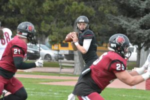 Reilly Hennessey (left) steps back to throw the football during spring camp at Central Washington University. The 21-year-old from Camas is putting in the work this summer to become the starting quarterback for the Wildcats. (Photo courtesy of CWU athletics)