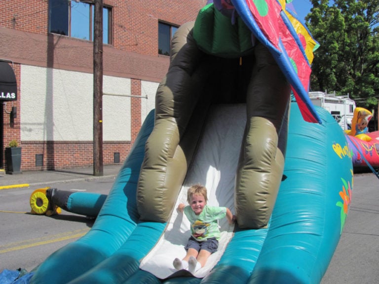A young attendee enjoys one of the slides on Kids Street during a past Camas Days celebration.