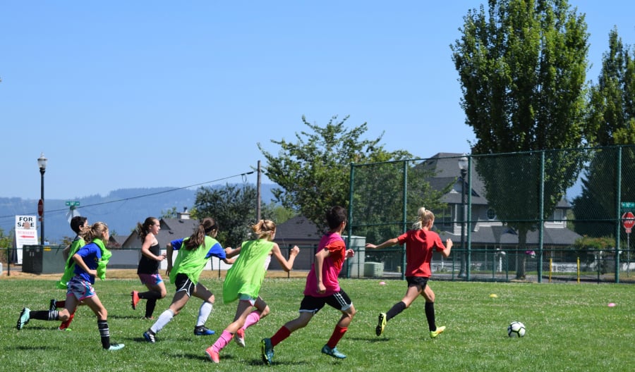 The players at Macaya Soccer Camp sprint for the ball during a scrimmage on July 25. This is the 14th anniversary of the camp created by Dan Macaya, a health and fitness teacher at Liberty Middle School and the new head boys soccer coach at Camas High School. (Tori Benavente/Post-Record)