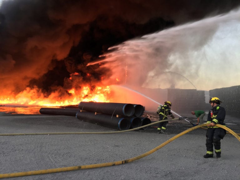 Firefighters attacked a commercial fire, burning through a storage yard of plastic pipe at Advanced Drainage Systems Inc. (ADS), in Washougal, Friday, July 28, at about 8 p.m. &quot;An electrical line had draped itself on top of one of the piles, where an electrical arc from the wires started the fire,&quot; Ron Schumacher said Monday.