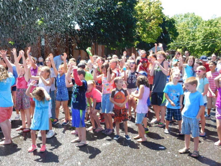 Children squealed with delight, as Bathtub Race Coordinator Pat Ray (not pictured) sprayed them with water from a Camas-Washougal Fire Department hose, in between each Camas Days bathtub race Saturday.