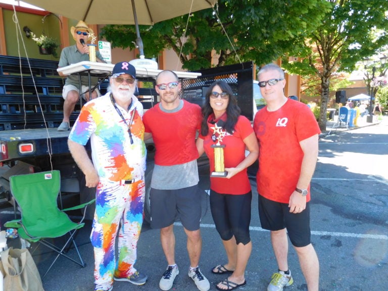 Bath Tub Race Coordinator Pat Ray presented the iQ Credit Union team -- Jerime Maloney, Dawn White and Richard Gooch (left to right) -- with a second place trophy, Saturday, at Camas Days.