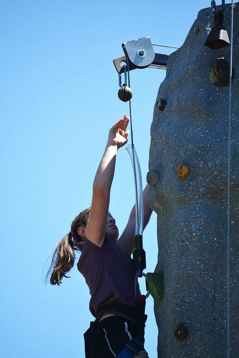 Reaching the top of the rock climbing wall at Camas Days.