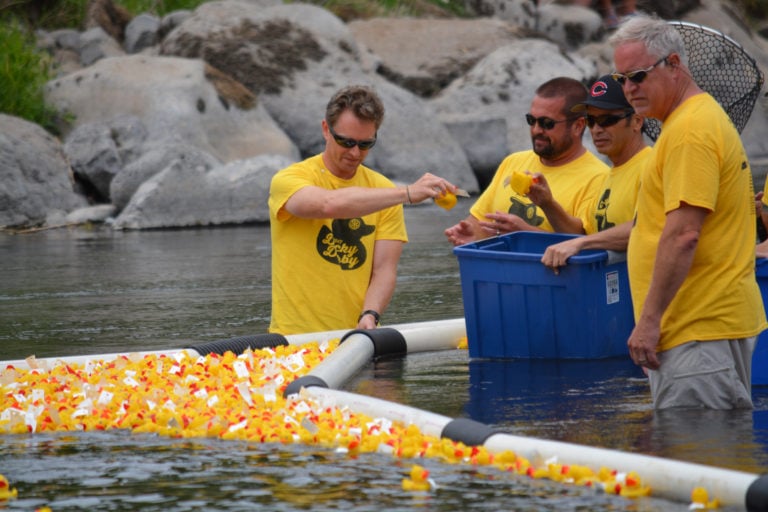 Camas-Washougal Rotary Club members count the ducks that crossed the finish line and earned prizes for the owners who paid $5 for a duck in the derby.