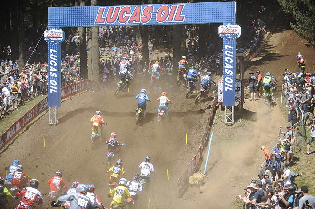 The 450 class riders head up Horsepower Hill, while fans stand on the hillsides and lean on the fences to get a closer look Saturday, at Washougal Motocross Park.