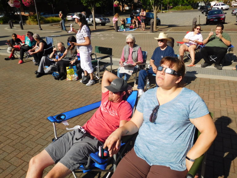 Camping chairs were spread throughout Reflection Plaza during the City of Washougal’s eclipse viewing event, Monday morning. Street lights came on during the eclipse. (Photo by Dawn Feldhaus/Post-Record)
