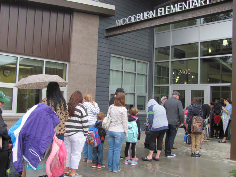 Parents and children line up at Woodburn Elementary in Camas for the first day of school in 2015.