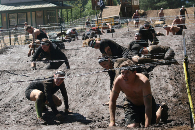 Crawling under barbed wire is one of the trademark obstacles of the Spartan Race.