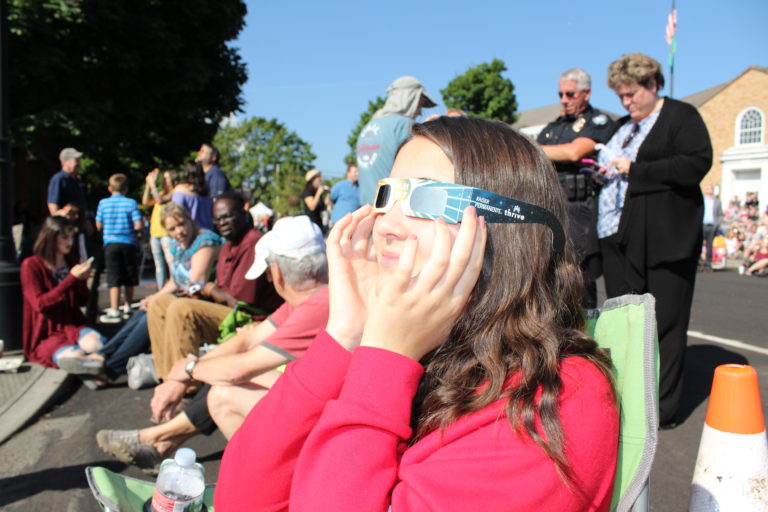 Eva Moyer-Wade, 15, of Portland, watches the 2017 solar eclipse in downtown Camas on Monday, Aug. 21. Photo by Kelly Moyer/Post-Record