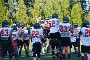 Camas Papermakers jump for joy before the start of football practice Monday, at Cardon Field. 