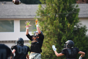 Grant Lewis leaps up to catch the football for Washougal during practice Tuesday, at Fishback Stadium. 