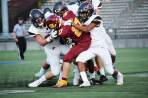 Camas defenders Dawson Ingram, J'Michael Shelton and Isaiah Abdul (left to right) slam into Greg Curtis, of Central Catholic, Friday, at Hillsboro Stadium, in Hillsboro, Ore. The 2016 Washington 4A state champion Papermakers defeated the Oregon 6A runner-up Rams 35-13 in the first game of the 2017 season. 